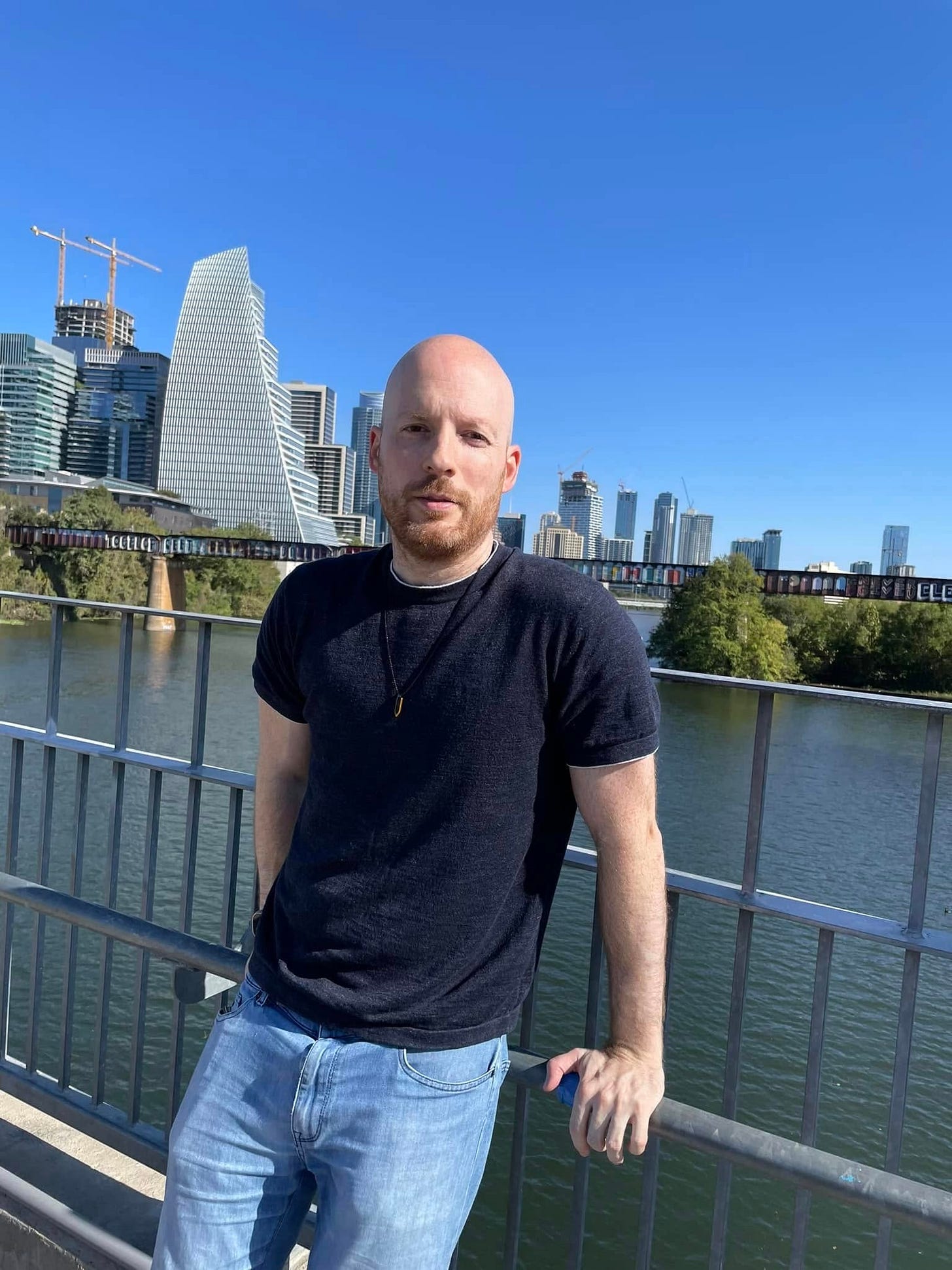 Oliver Emberton stands on a bridge, in Austin, Texas