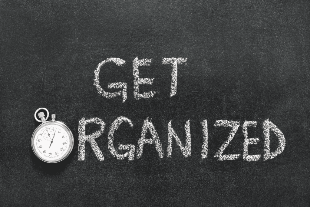 Blackboard with white chalk spelling Get Organized with a clock for the letter O.
