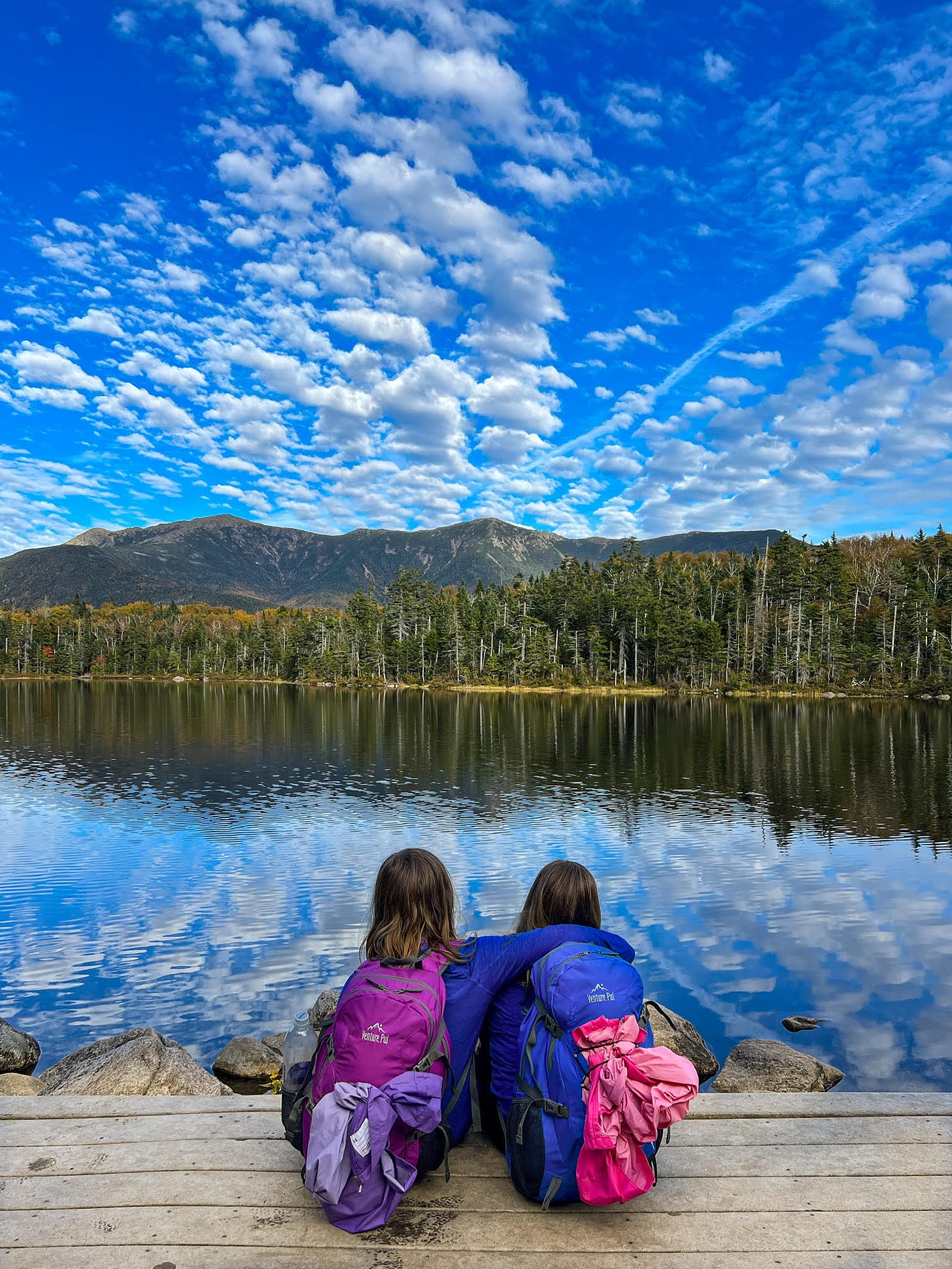 Two children sitting beside Lonesome Lake, New Hampshire