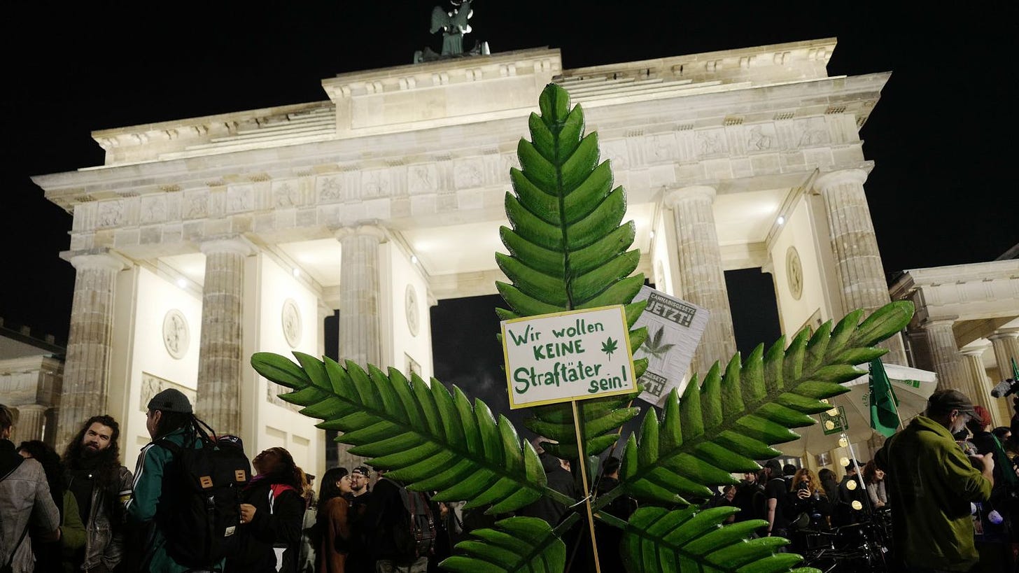BERLIN, GERMANY - APRIL 1: Cannabis enthusiasts smoke joints legally at the Brandenburg Gate at shortly after midnight on April 1, 2024 in Berlin, Germany. Germany's new cannabis law goes into effect today, bringing in a new era of legal cannabis consumption. Cannabis social clubs will also be allowed to grow their own marijuana beginning later this year.(Photo by Michele Tantussi/Getty Images)