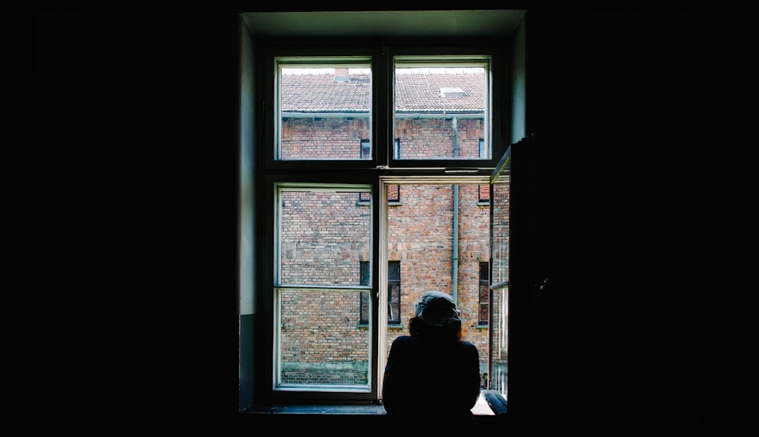 person standing in front of open window person standing in front of open window