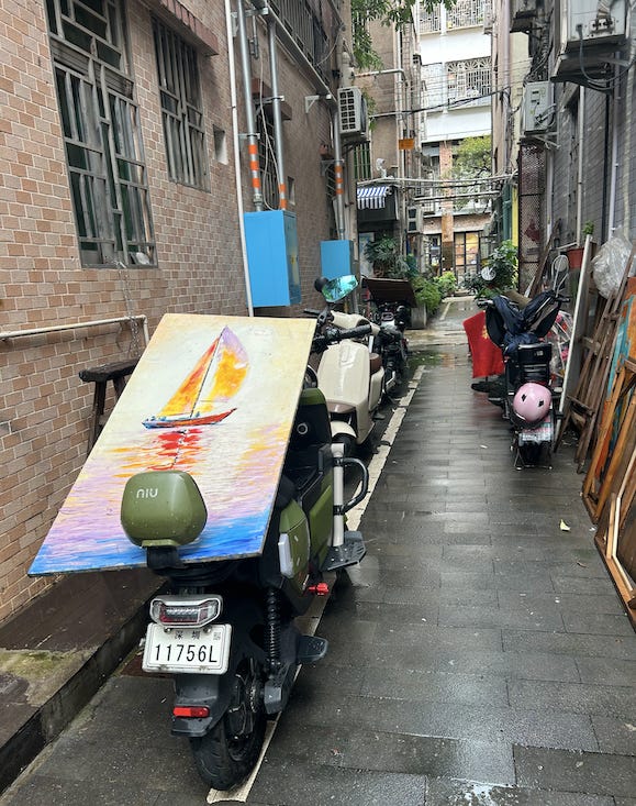 A scooter parked in a alley

Description automatically generated