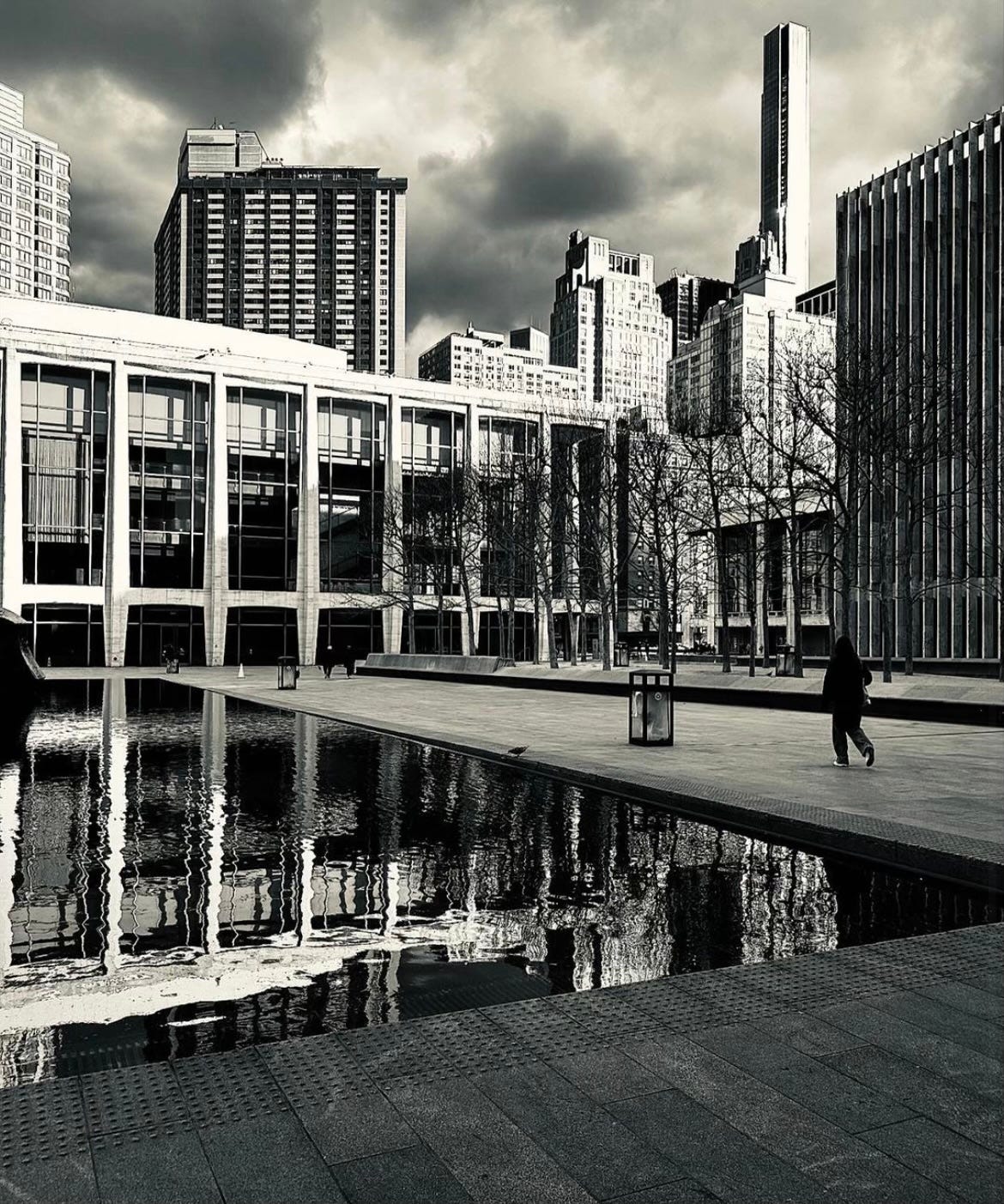 A person walking through the Lincoln Center arts complex