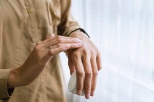 Person applying lotion to hands