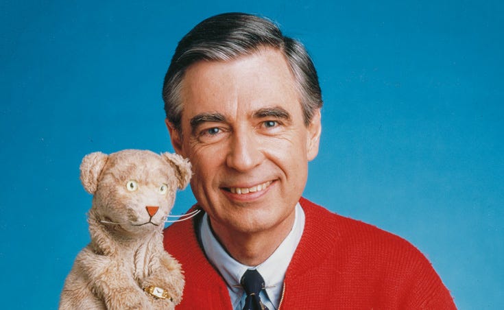 Mr. Rogers wearing red sweater