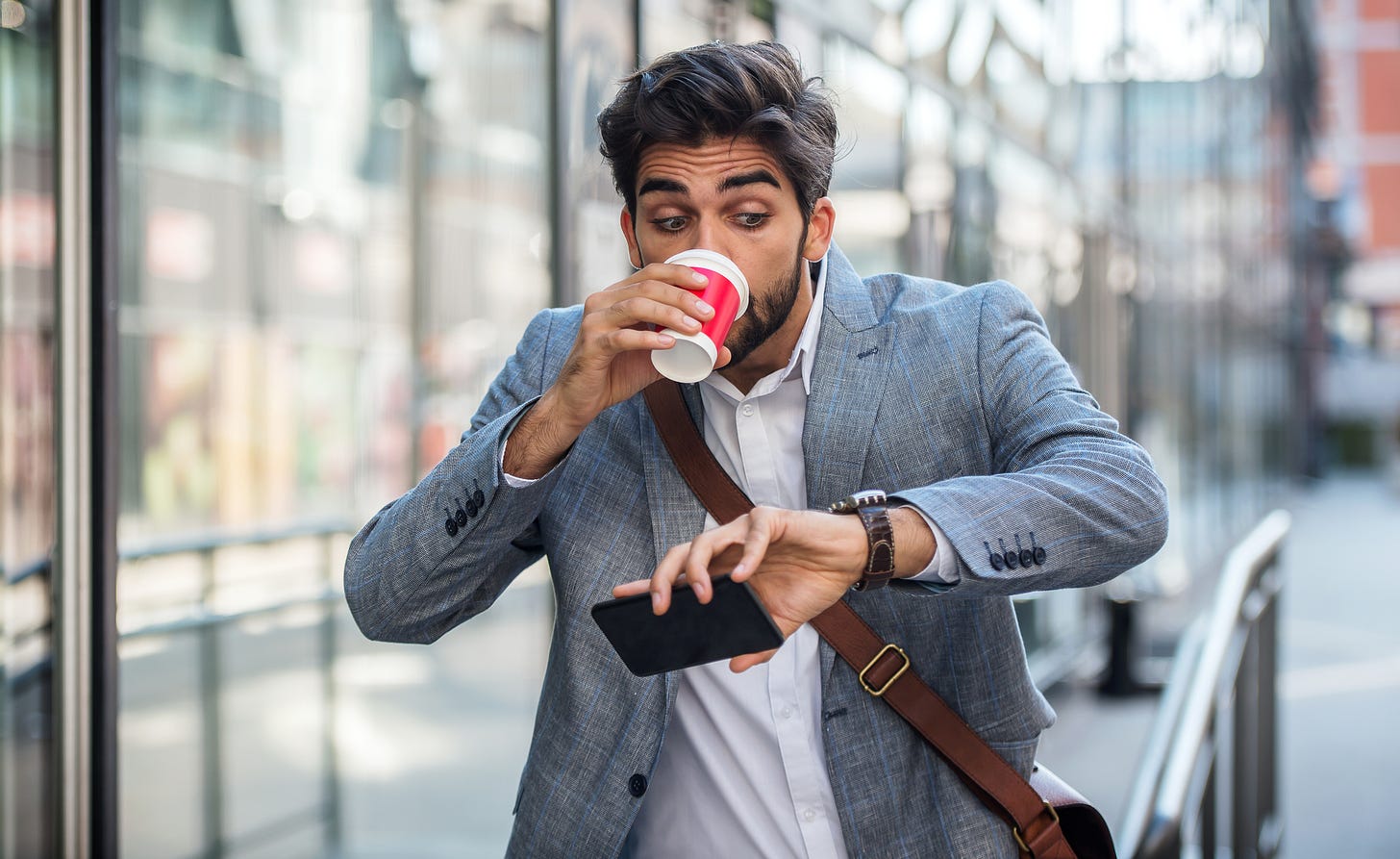 Young businessman checks watch and realizes he's late for a job interview.