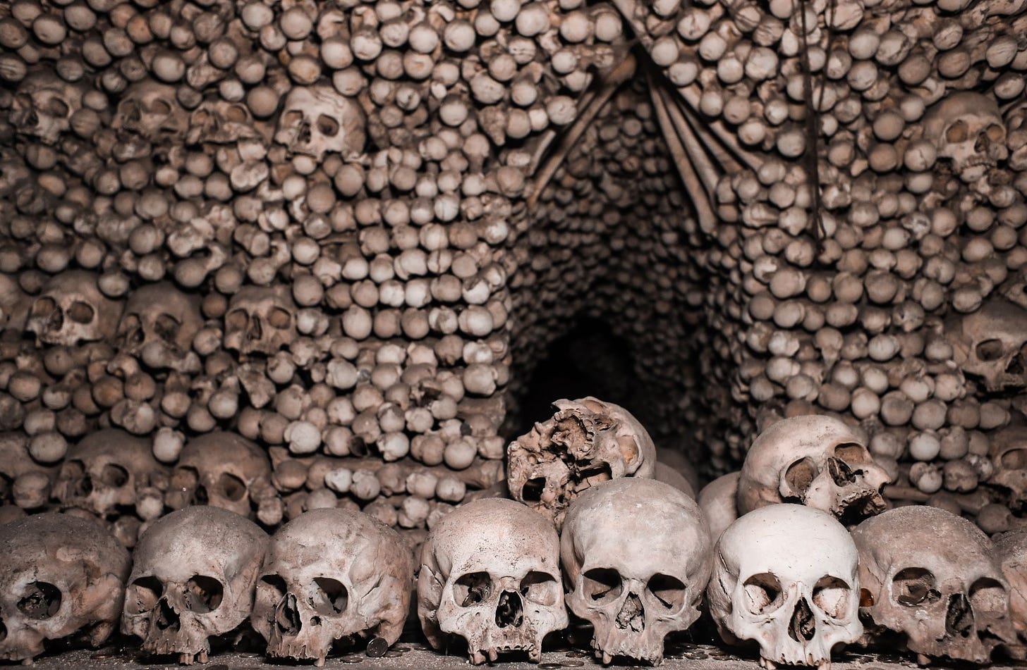 wall lined with human skulls by rachel claire via pexels