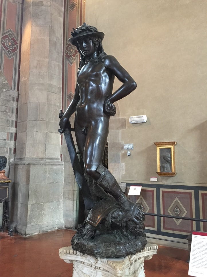 A statue of a naked person

Description automatically generated