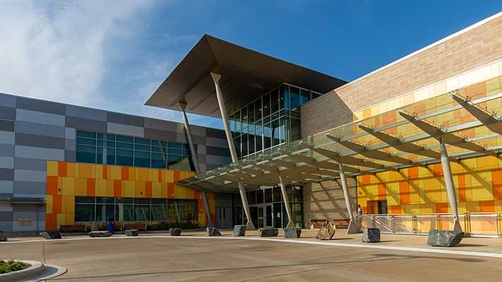 A large building, the wheaton library, covered in bright orange panels. 