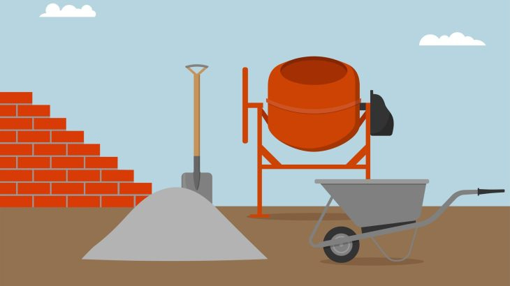 Brick wall, concrete mixer, wheelbarrow, bucket and spade.