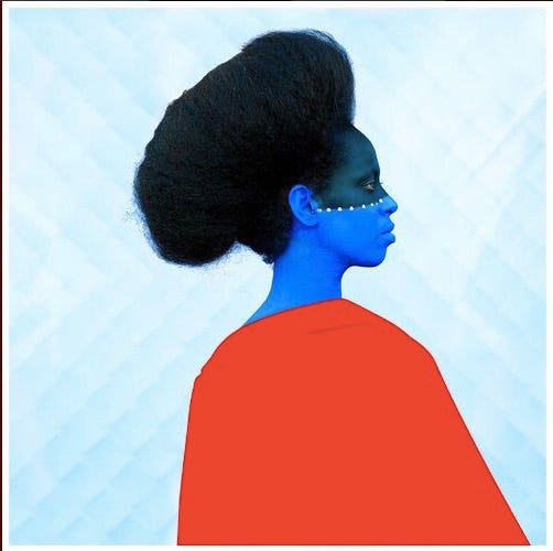 An Ethiopian woman with the bottom half of her face painted blue, wearing a red cape, in front of a blue background