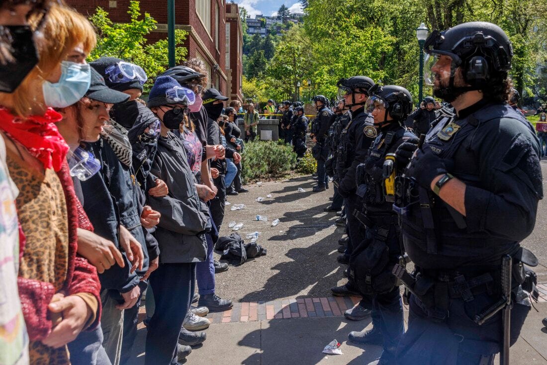 Pro-Palestinian students and activists face police officers after protesters were evicted from the library at Portland State University in Portland, Ore., in May.