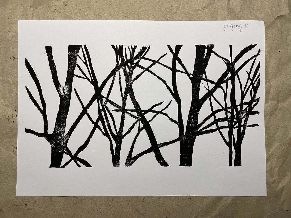 Photo of a linocut of trees in black ink