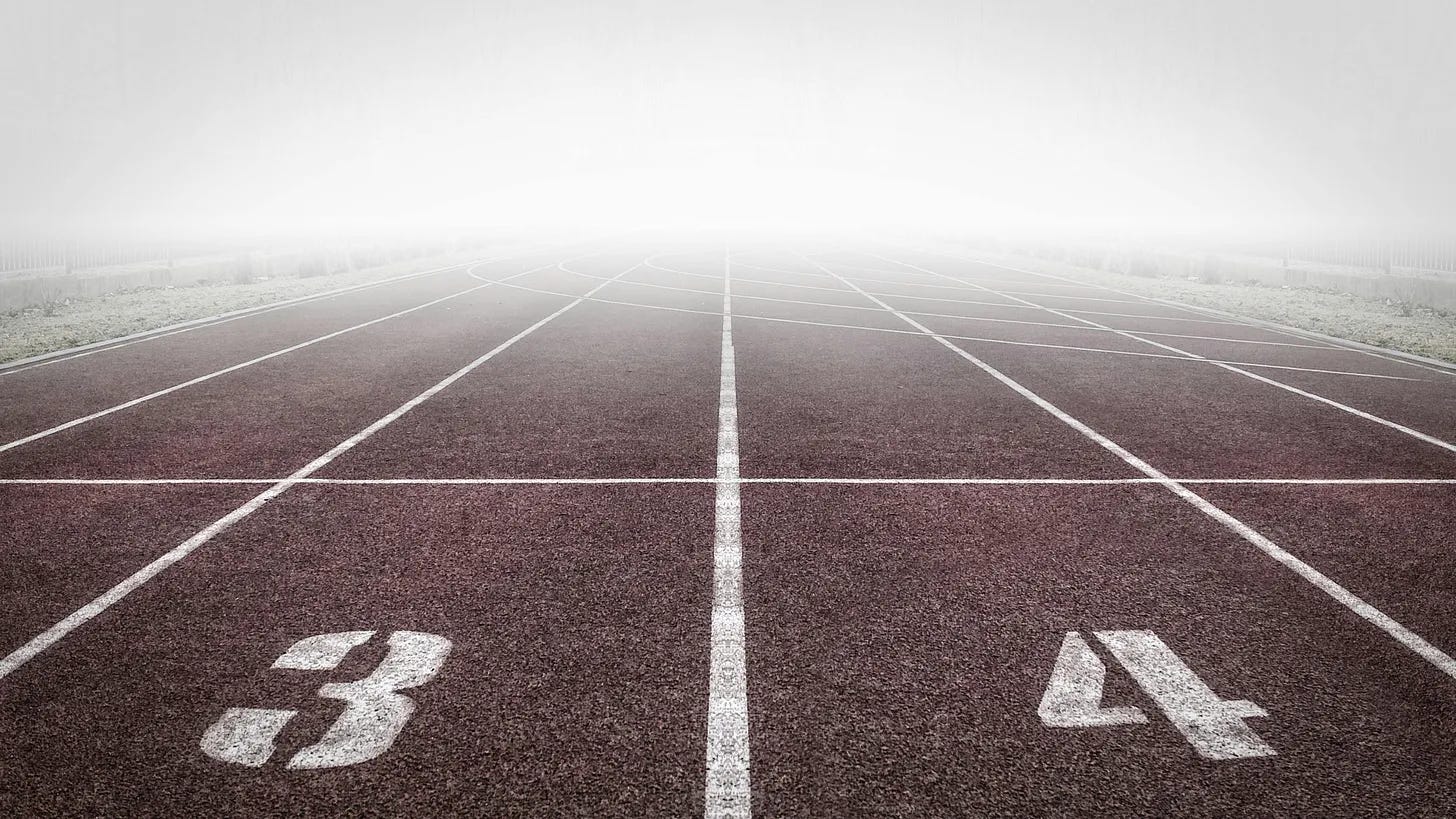 A foggy empty race track showing several empty race lanes. 