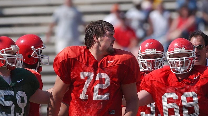 Georgia's Brian Jordan (No. 59) and Chris Abbott (69) escorts teammate Daniel Inman (72) off the field as he continues to yell at teammates Saturday, April 17, 2004 in Athens. (JOHNNY CRAWFORD/AJC file)