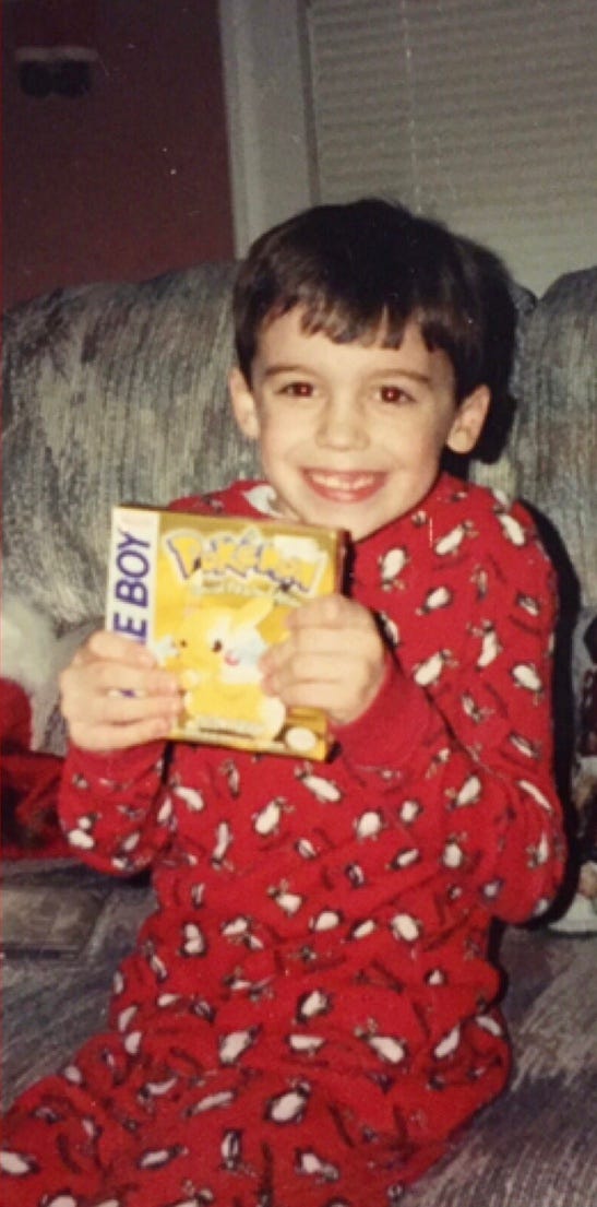 A photograph of Justin on Christmas day morning with his copy of Pokémon Yellow in 1999