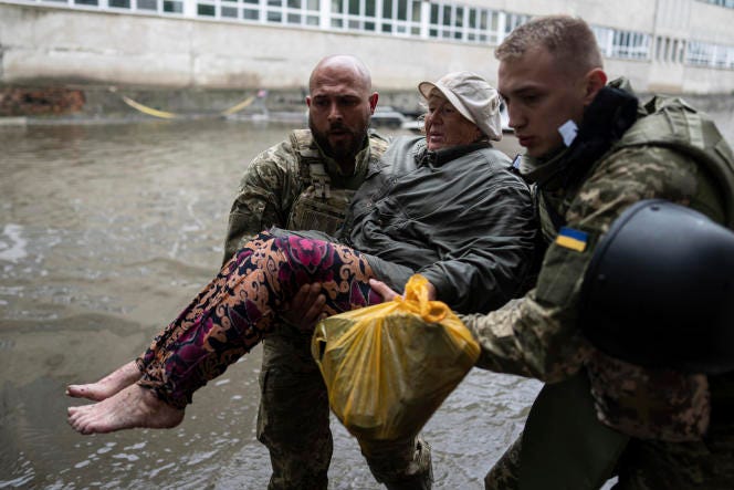 Ukrainian rescuers in Kherson, Ukraine, on June 11, 2023.