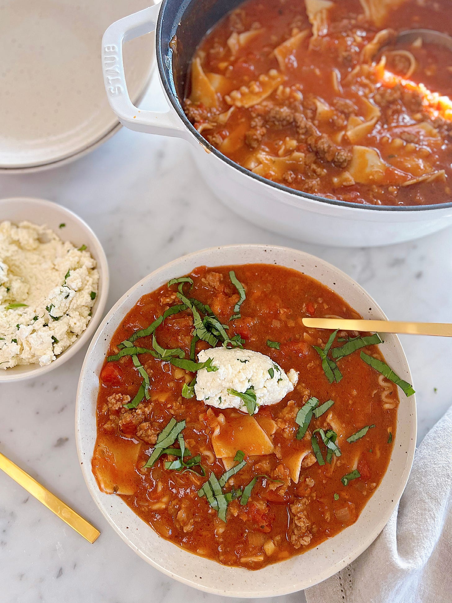 Gluten free and dairy free lasagna soup in a bowl with pot of soup