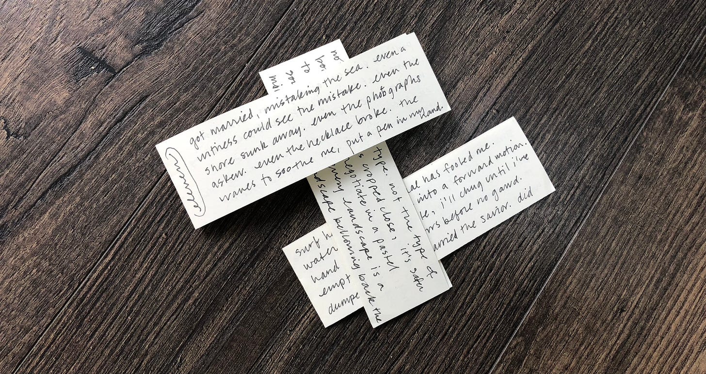 three folded scraps of paper with black ink handwriting laying woven on a wooden floor