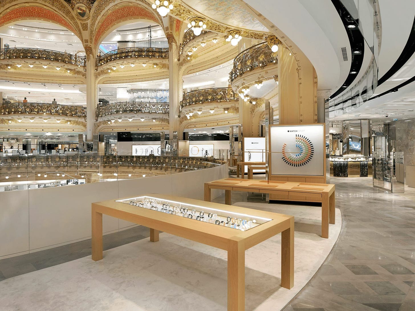 Apple Watch at Galeries Lafayette photographed before the department store opened. An Apple Watch display table is in the bottom center of the frame.