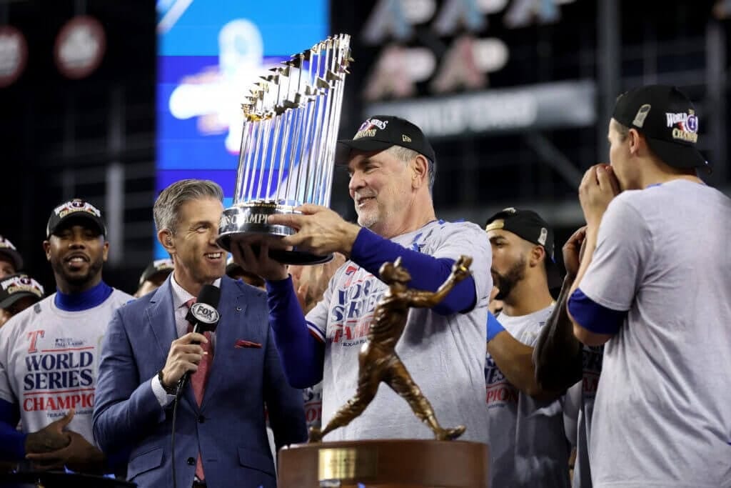 PHOENIX, ARIZONA - NOVEMBER 01: Manager Bruce Bochy of the Texas Rangers hoists the Commissioner&#039;s Trophy after the Texas Rangers beat the Arizona Diamondbacks 5-0 in Game Five to win the World Series at Chase Field on November 01, 2023 in Phoenix, Arizona. (Photo by Christian Petersen/Getty Images)