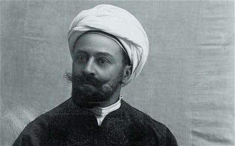 a black and white photo of a European man with a large moustache wearing a Hejazi turban