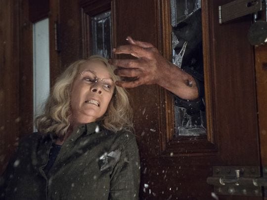 jamie lee curties avoiding michael myers hands through window halloween movie 2018]