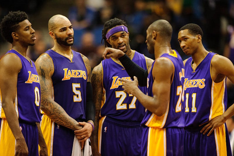 MINNEAPOLIS, MN - DECEMBER 14: Kobe Bryant #24 of the Los Angeles Lakers speaks with teammates Nick Young #0, Carlos Boozer #5, Jordan Hill #27 and Wesley Johnson #11 during a timeout in the fourth quarter of the game against the Minnesota Timberwolves on