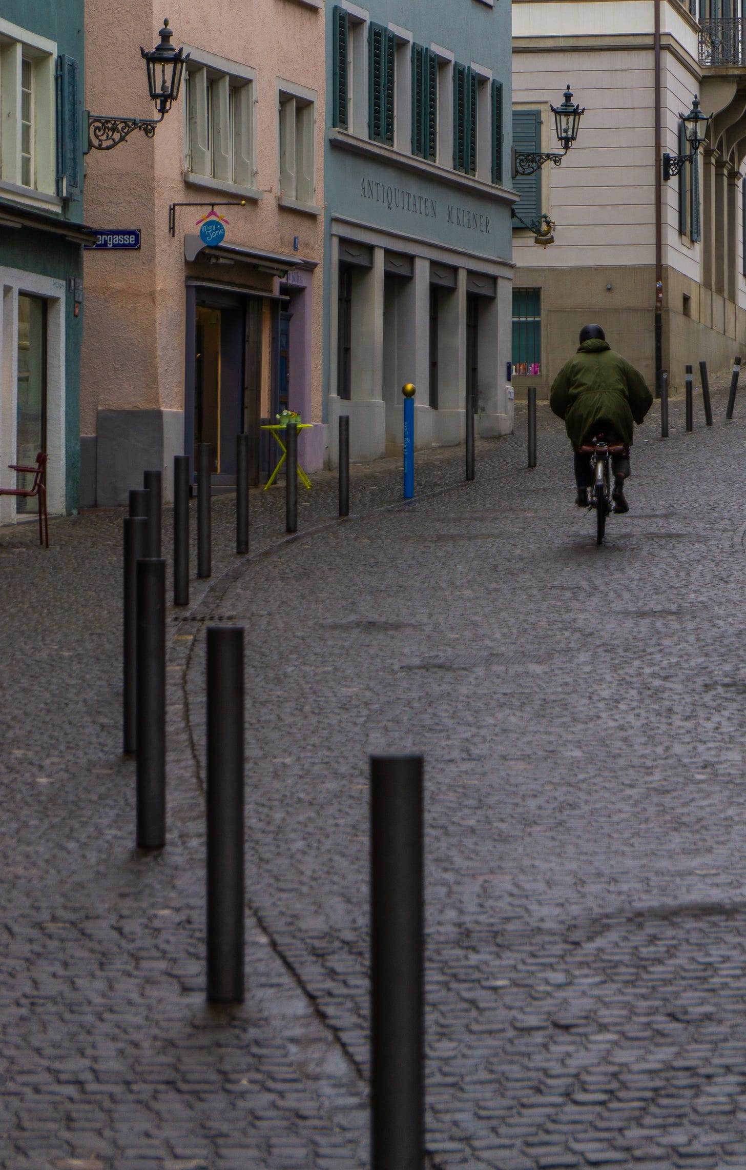 A man cycling up a curved street