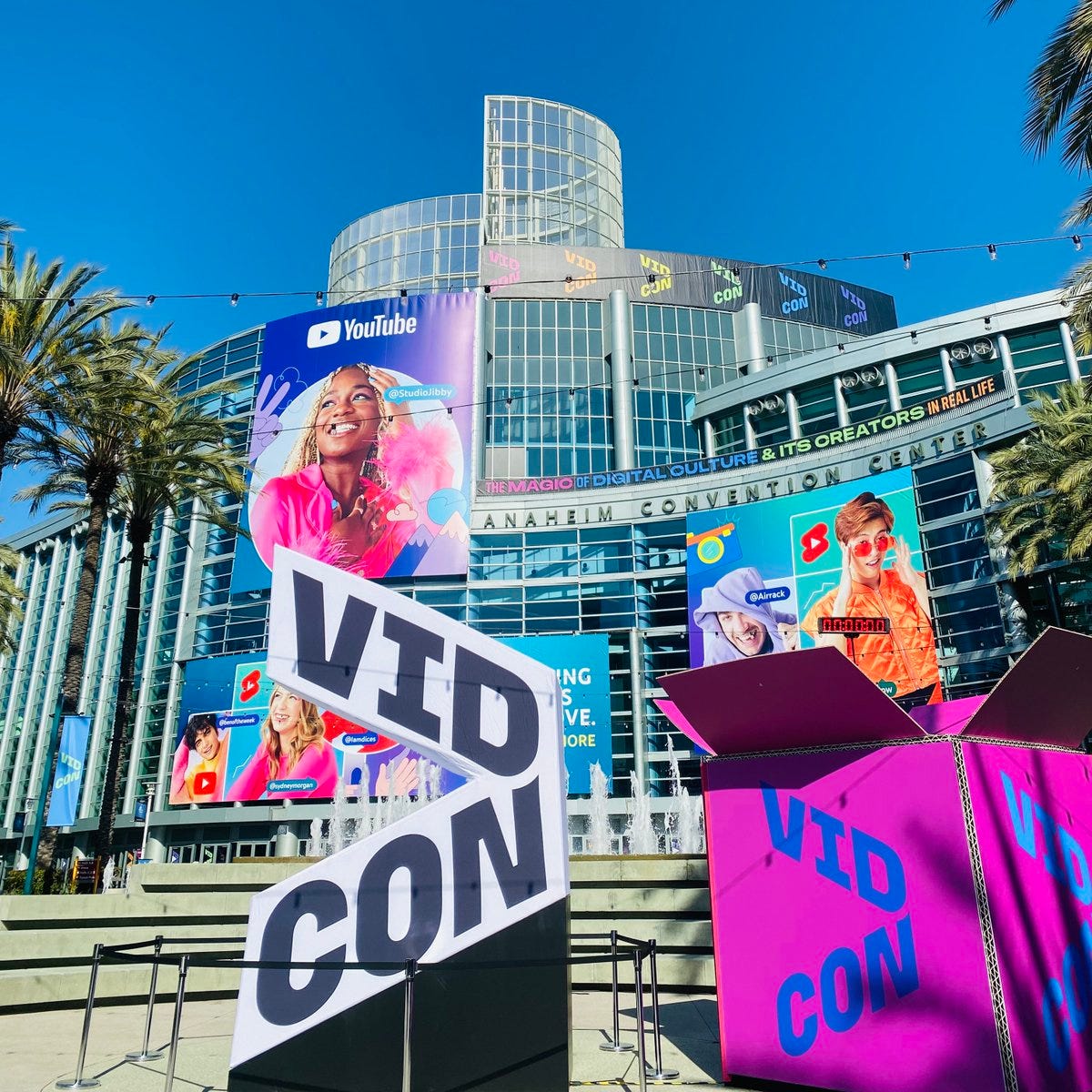 VidCon scene featuring the YouTube marquee with select creators such as fitness influencer Studio Jibby