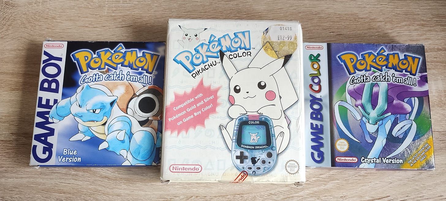 My copies of Pokémon Blue and Pokémon Crystal, with my Pocket Pikachu Color. I feel like this was the peak of my enjoyment of the Pokémon franchise. My copies of Pokémon Blue and Pokémon Crystal, with my Pocket Pikachu Color. I feel like this was the peak of my enjoyment of the Pokémon franchise.