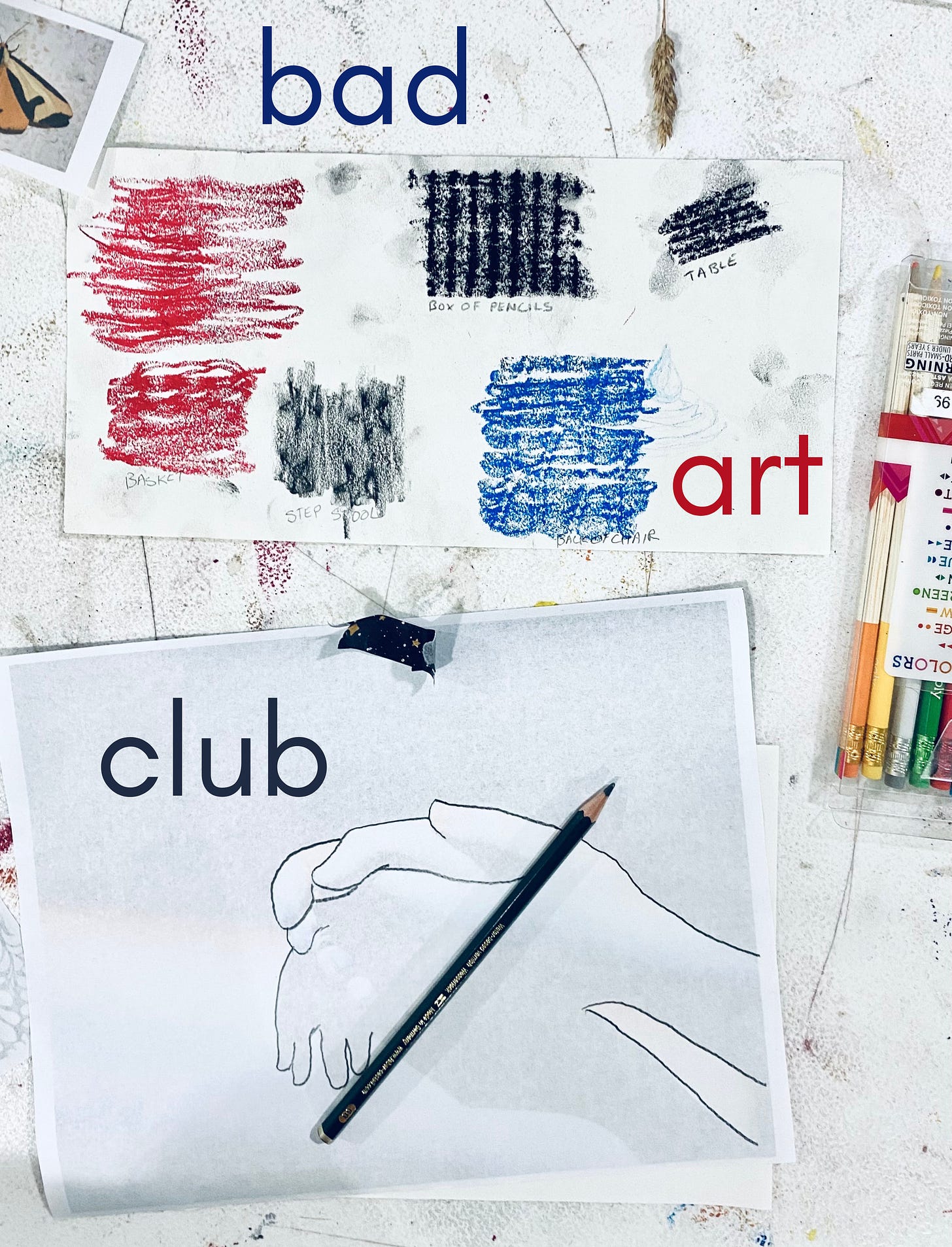A art table covered in art materials incluidng color pencils, the start of a drawing of two hands, an image of a moth, and a piece of paper with red, blue, and black rubbings on them. "bad art club" is written on top of the image in red, blue, and grey.