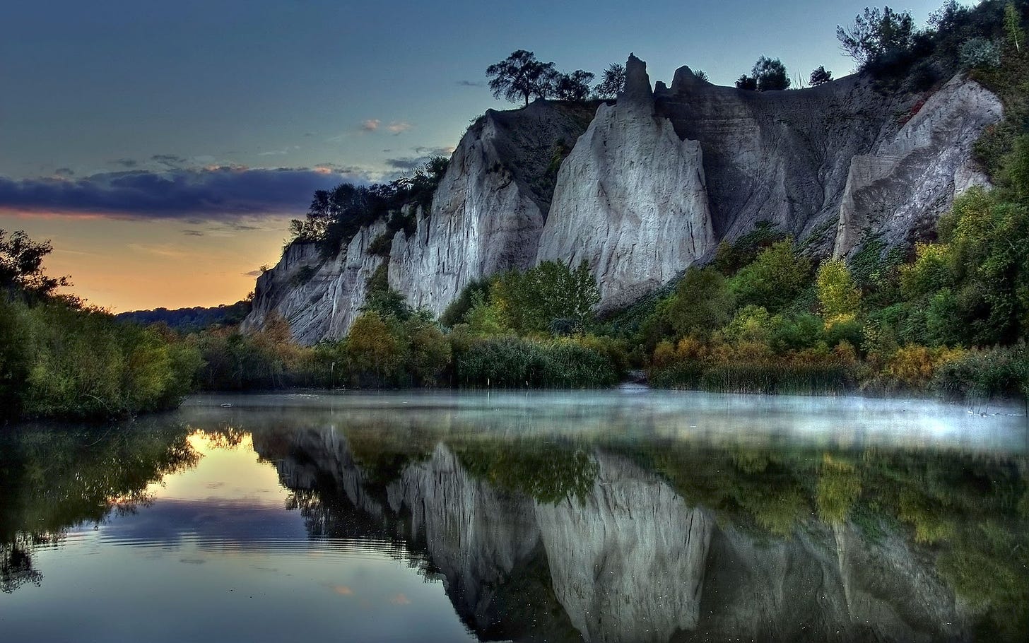 Serene Cliffside Lake Reflection - HD Wallpaper