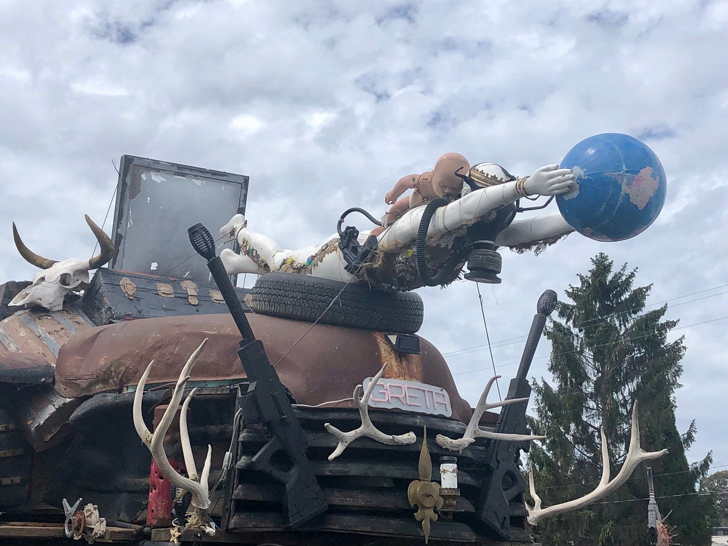 a goofy photo of a art piece where a astronaut is diving after a globe