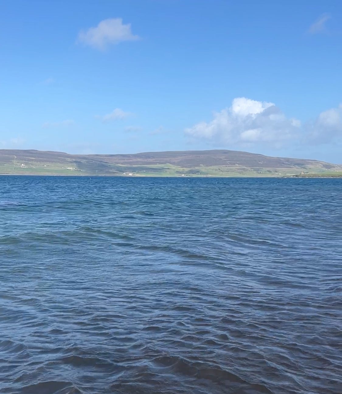 image taken from Evie beach overlooking the sea and Rousay, one of the islands of Orkney