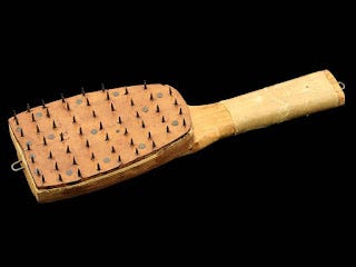 Paddle used to perforate mail for disinfection