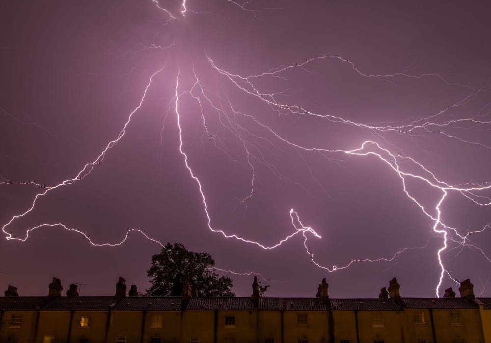 Lightning in purple sky over London illustrating vibrational frequency