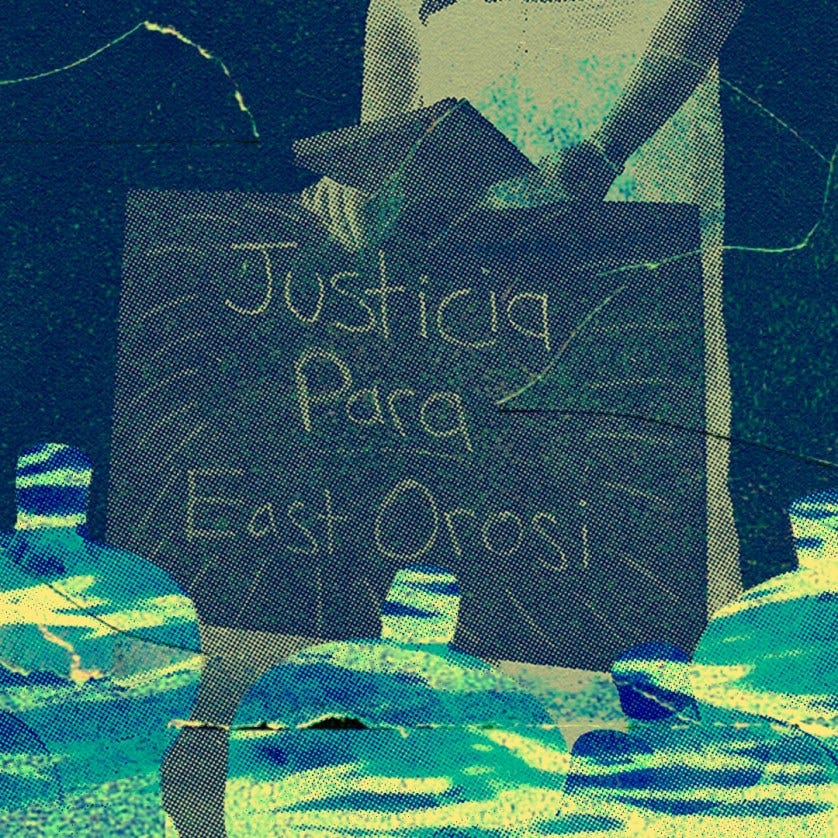 A person holding a "Justicia para East Orosi" sign