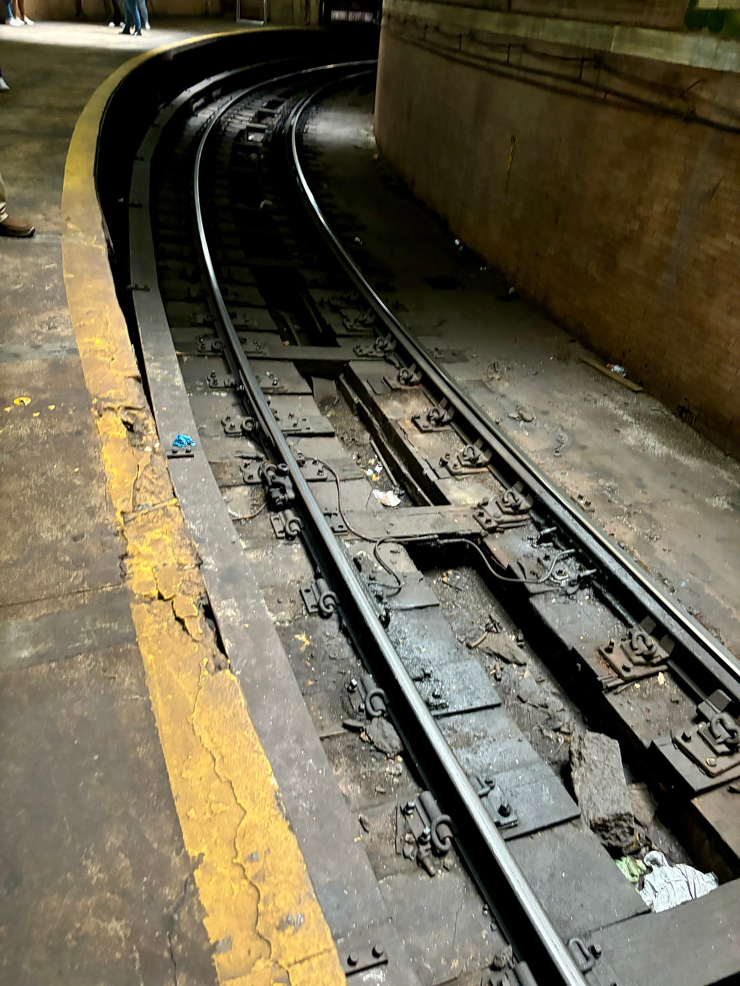 The subway tracks at City Hall Station. The Third Rail is on the side closest to the platform.