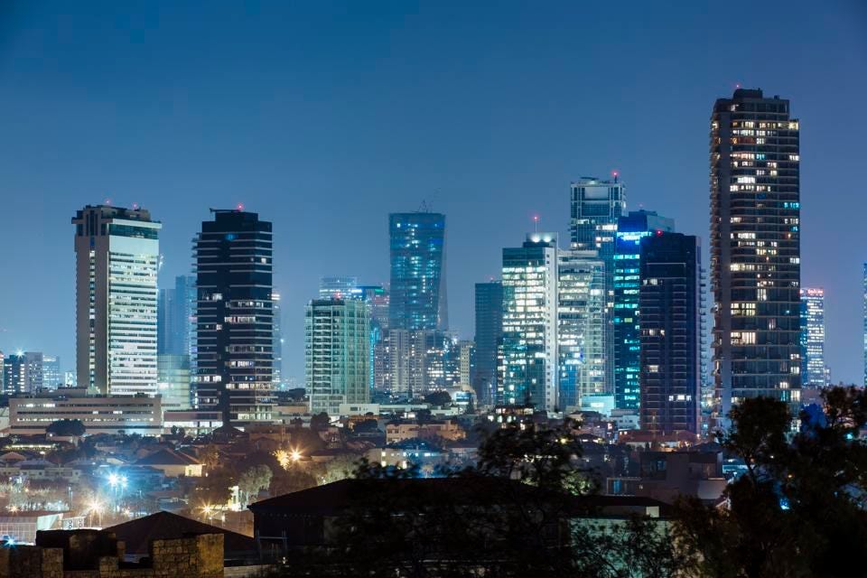 Modern illuminated skyscrapers at night in Tel Aviv downtown, Israel Modern illuminated skyscrapers at night in Tel Aviv downtown, Israel