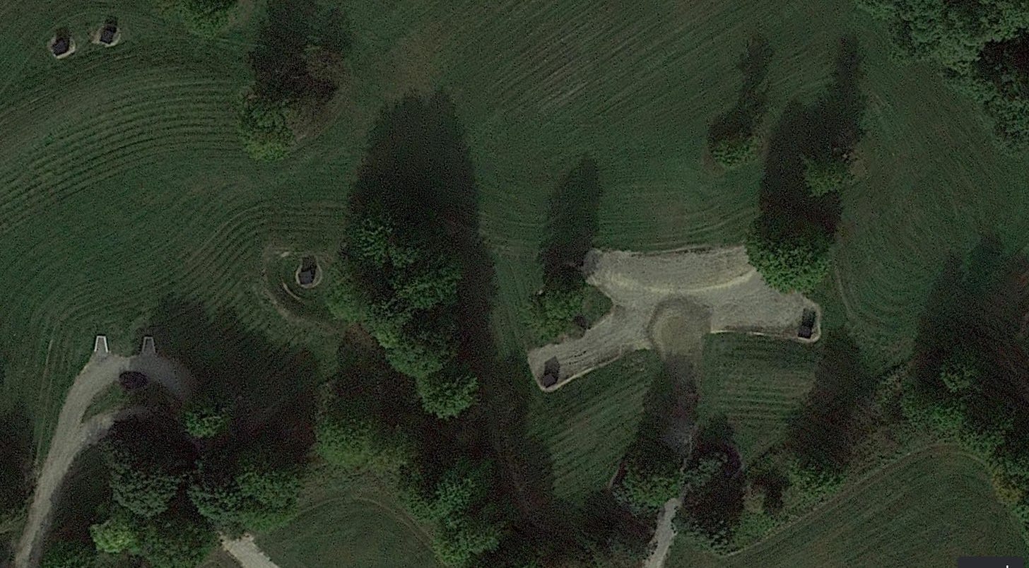 Arial view of farmland with a scraped piece of land and maybe a structure