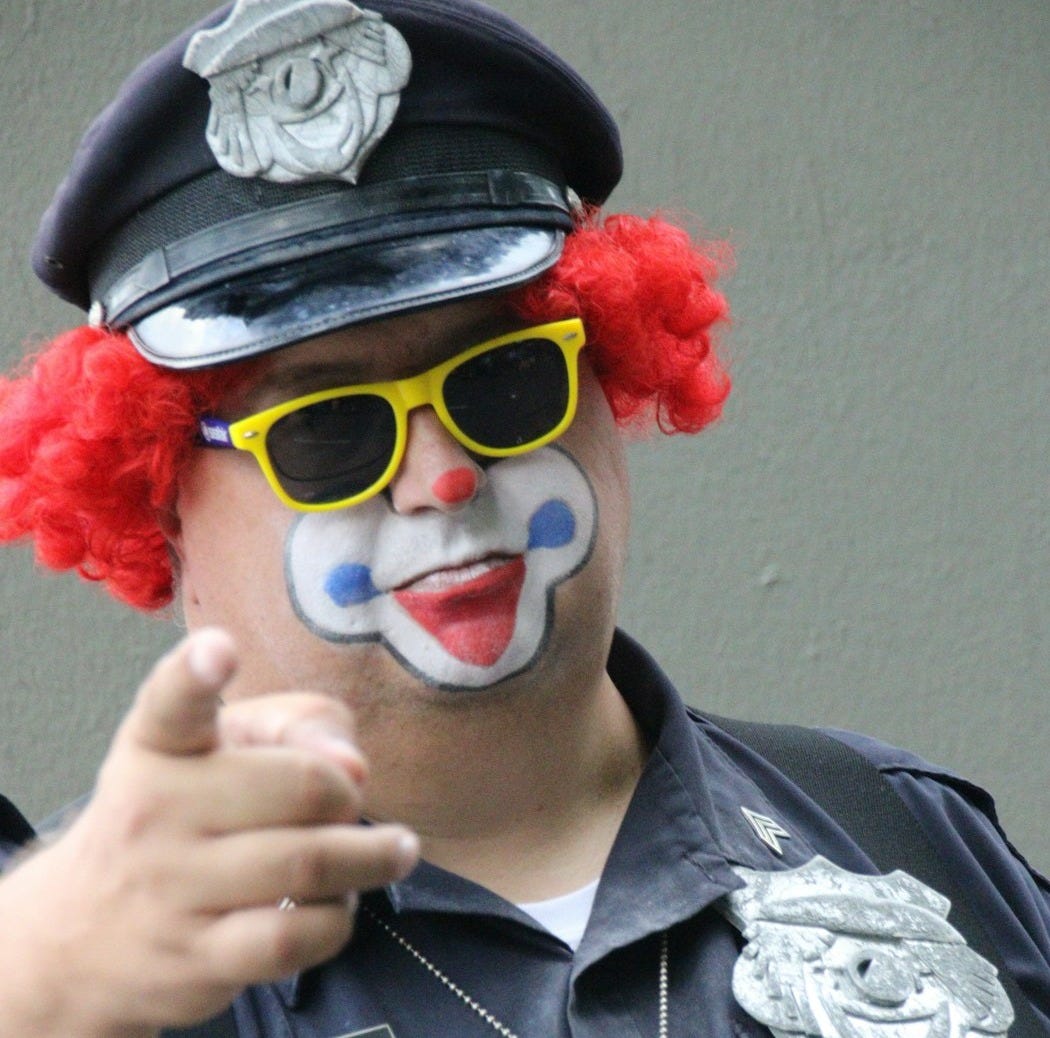 man in black leather jacket with red wig