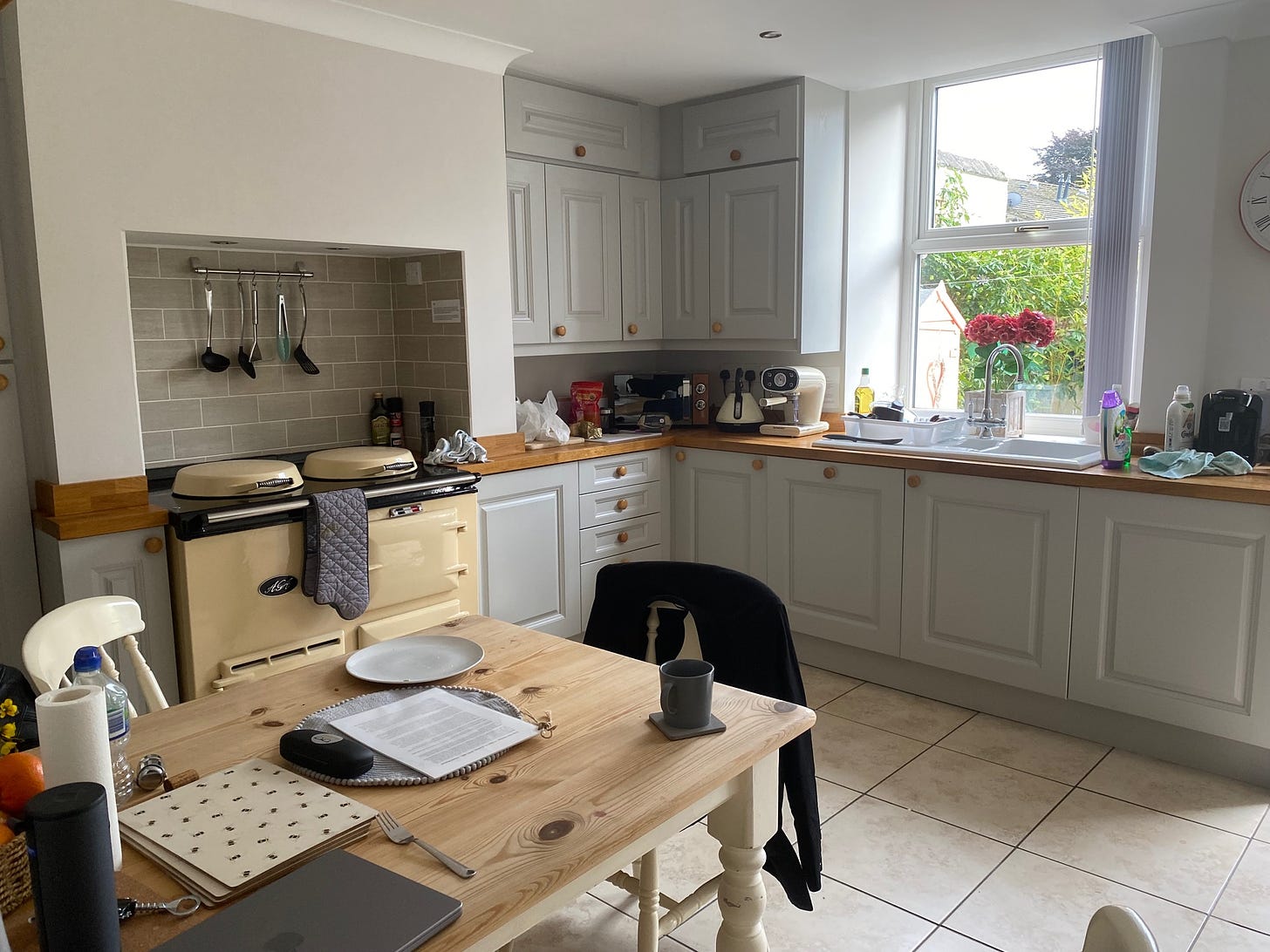 A kitchen with a table and an AGA cooker