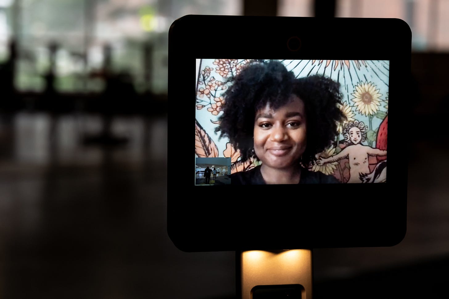 A portrait of a CoLaborator on the screen of a telepresence robot in the Future Present exhibition.