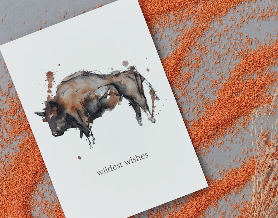 Card with watercolor bison by Tiffanie Andrews and text reading 'wildest wishes'