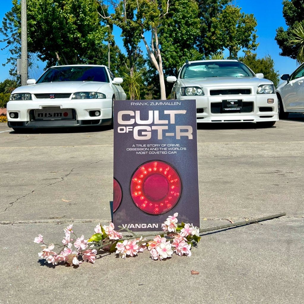 The cover of new car book 'Cult of GT-R' between an R33 Skyline GT-R Autech sedan and a Stagea 260RS station wagon.