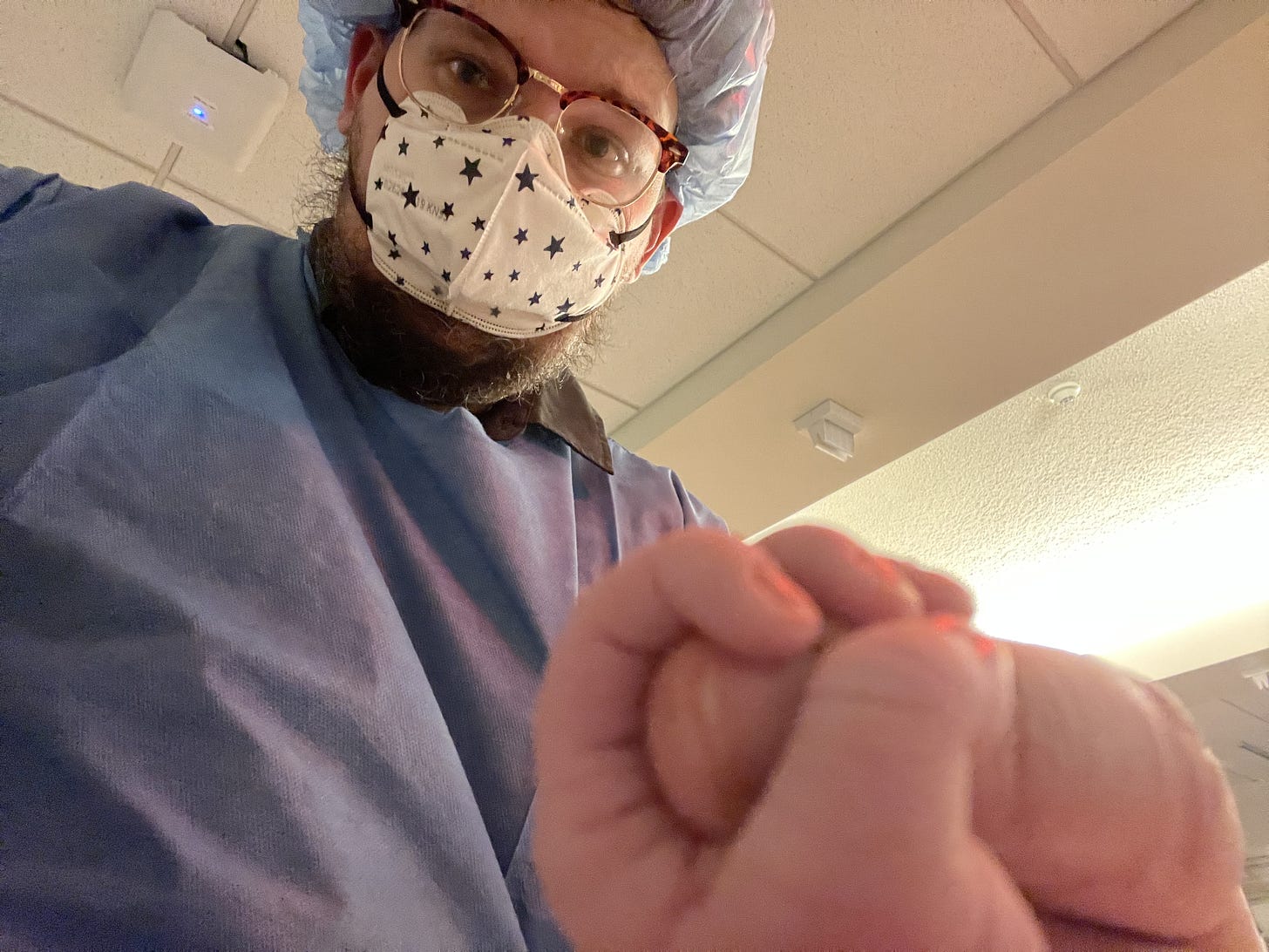 Kelsey Atherton in the NICU, with his finger gripped by the hand of his newborn. It was a sensor-rich environment, this selfie camera was about the least intrusive angle.