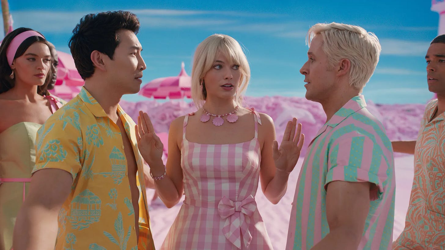 An Asian man wearing a yellow beach shirt and a white blonde man wearing a pink-and-turquoise-striped button-up shirt are being held back from each other by a blonde woman in a pink-and-white checkered dress. They are flanked by a brown-haired woman and a Black man while standing on a plastic pink beach with blue sky.