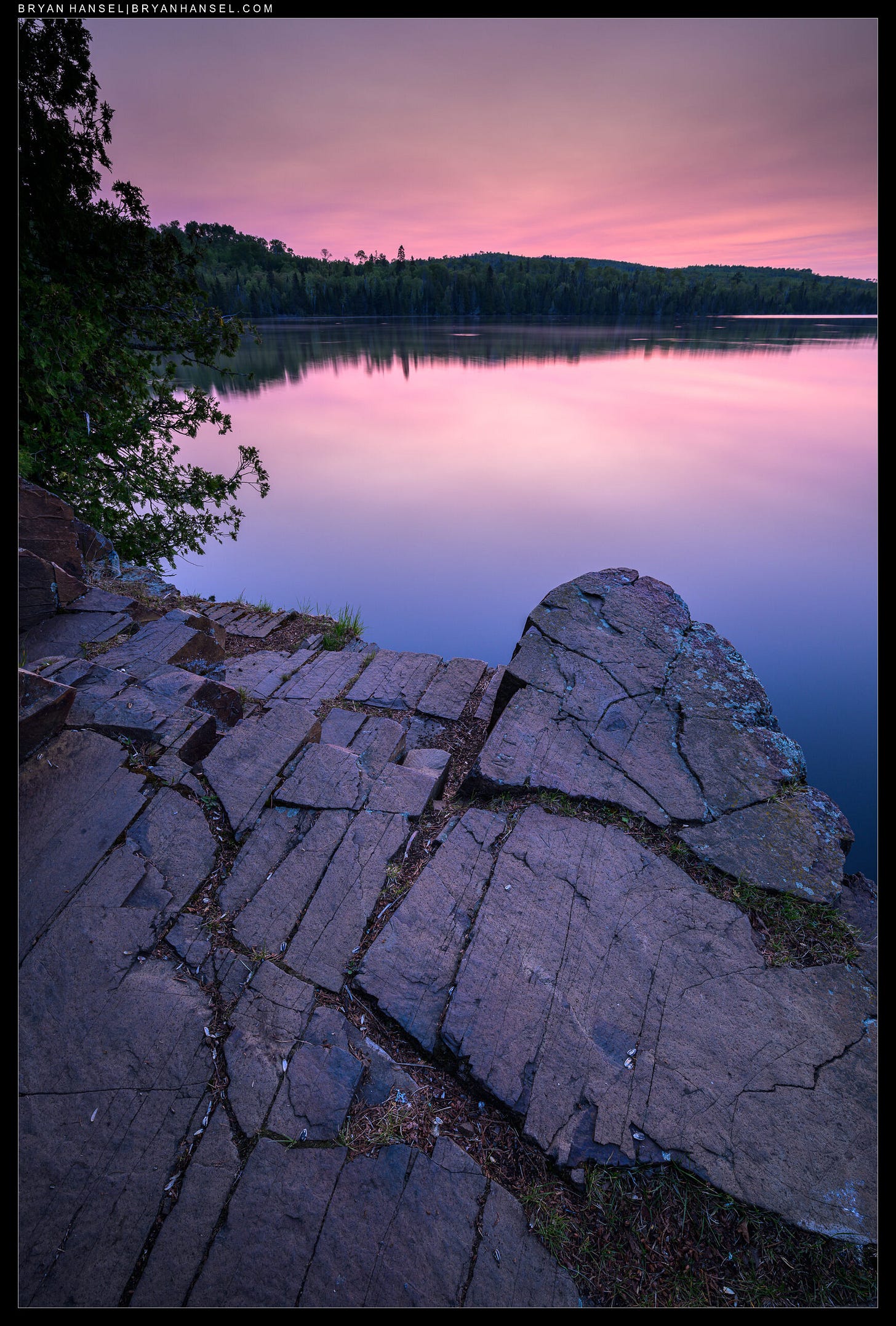 A photo of a purple sunrise over a rock formation
