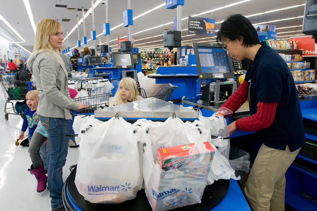 woman and child at supermarket checkout